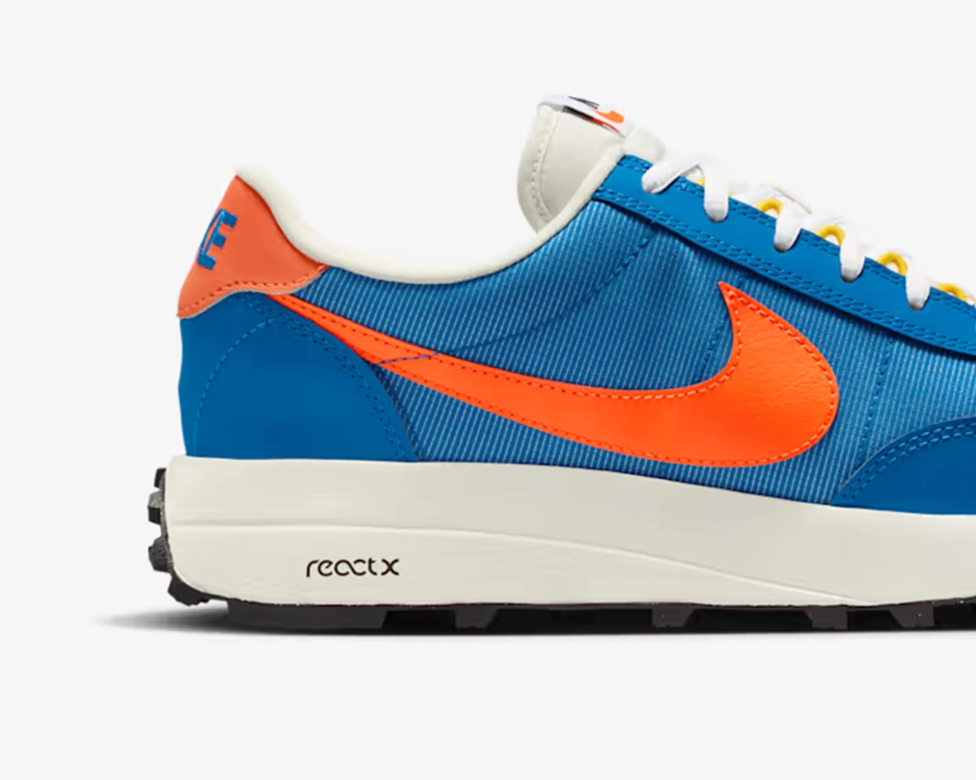 Blue and orange Nike sneaker with white sole and "react x" text on the midsole.