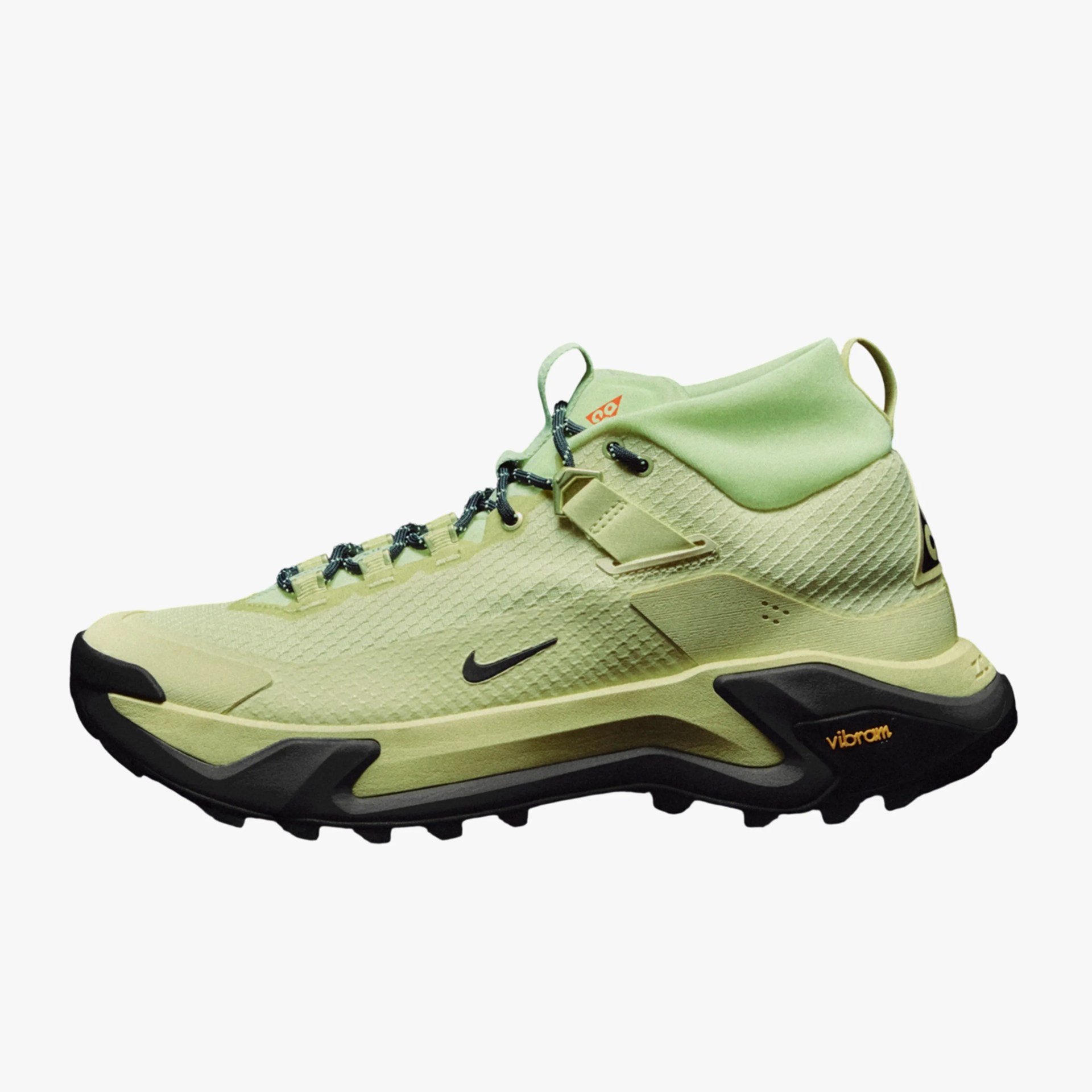 Light green Nike hiking shoe with black Vibram sole and black laces, side view.