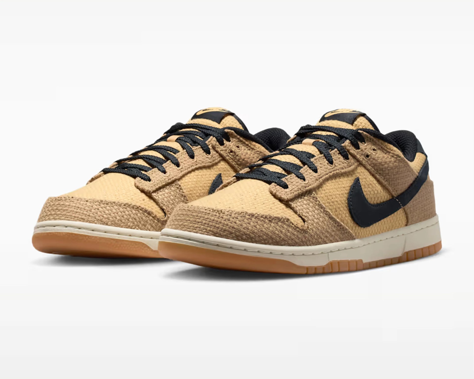 Pair of tan and brown woven low-top sneakers with black Nike swoosh and black laces on a white background.
