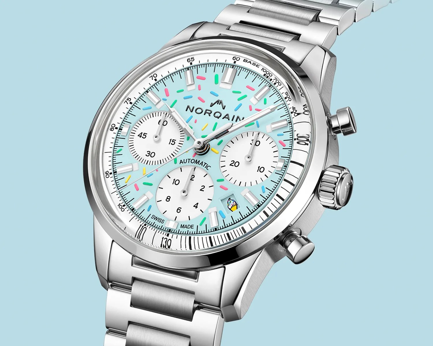 Silver metal chronograph watch with light blue dial, colorful sprinkles design, and small ice cream cone icon near 4 o'clock.
