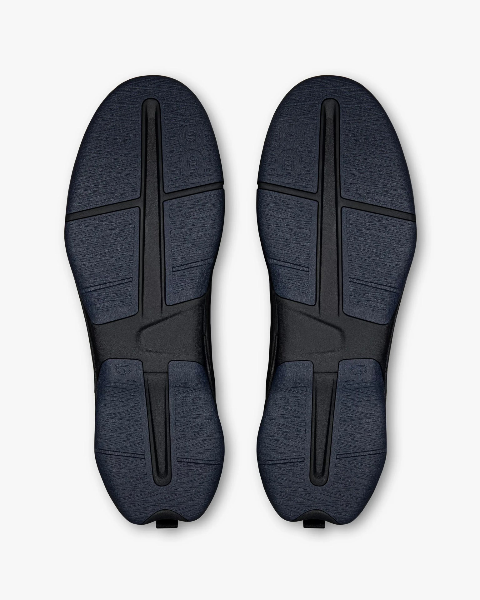 Pair of black shoe soles with textured navy blue rubber grip sections and embossed branding.