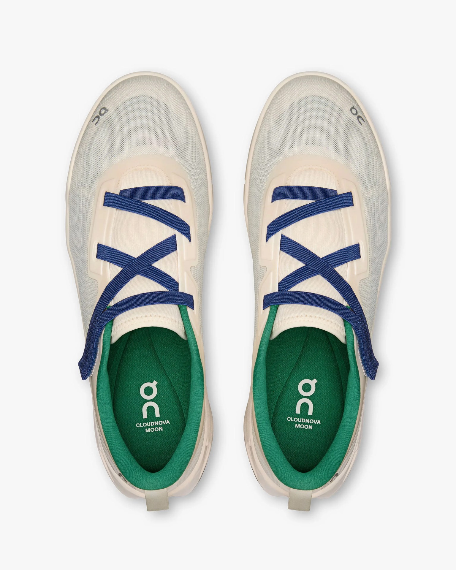Pair of beige On Cloudnova Moon sneakers with blue laces and green inner lining, viewed from above.