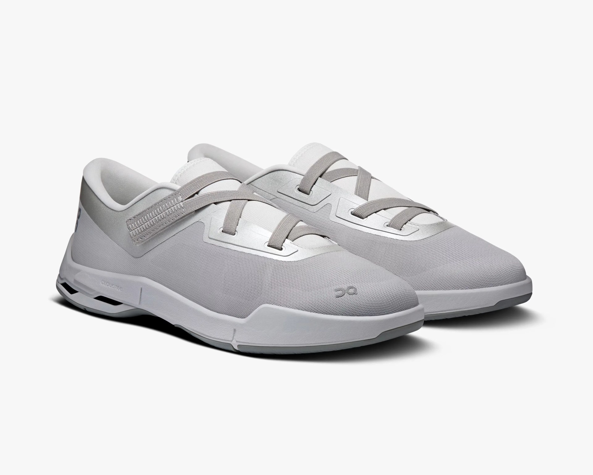 Pair of light gray athletic shoes with mesh upper, gray laces, and white cushioned soles on a white background.