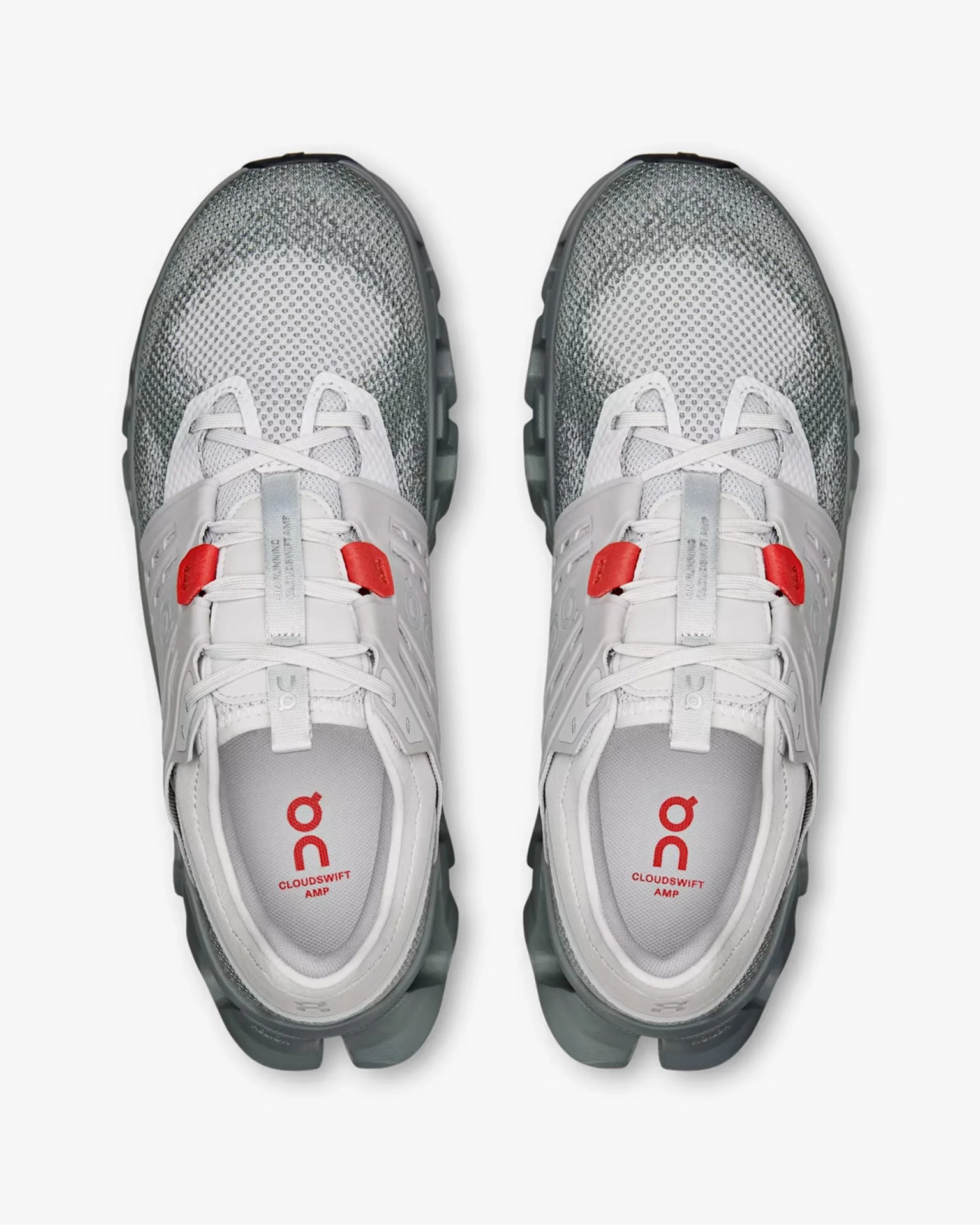 Pair of white and gray On Cloudswift AMP running shoes with red lace loops, viewed from above.