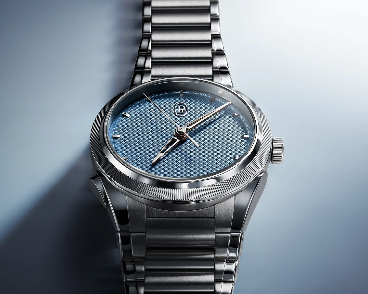 Silver stainless steel wristwatch with a textured blue dial and silver hour markers on a light blue surface.