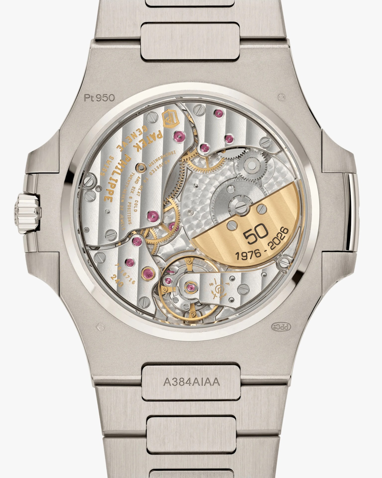 Back of a platinum Patek Philippe watch showing intricate mechanical movement with gold rotor marked "50 1976-2026".