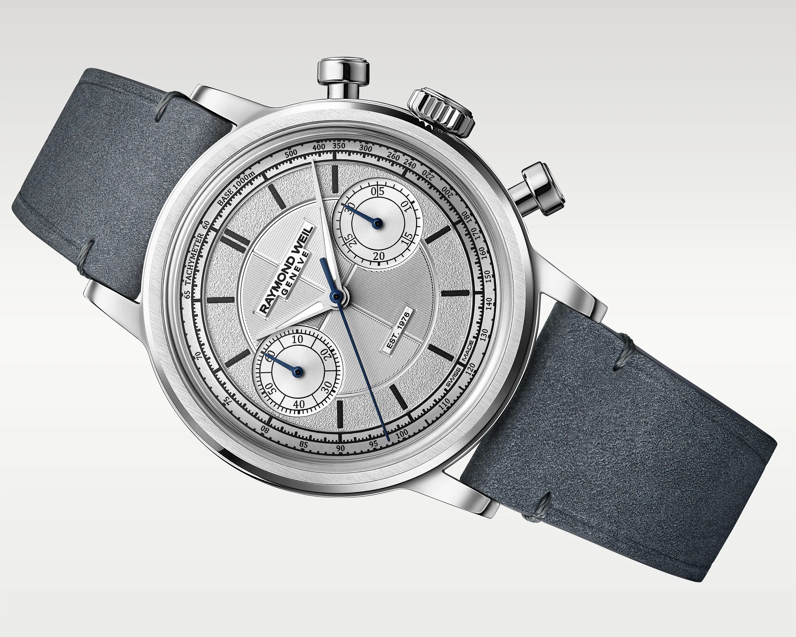 Silver Raymond Weil chronograph watch with textured dial, blue hands, and dark gray leather strap.