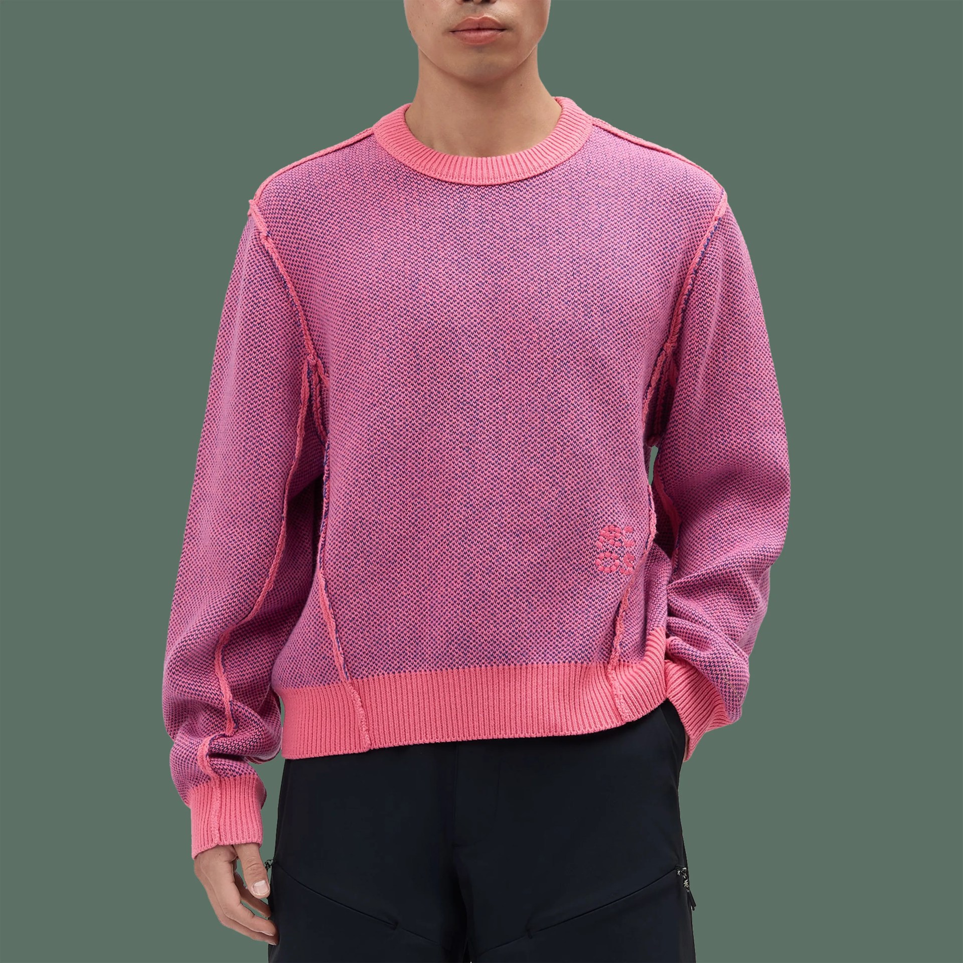 Pink and purple textured knit sweater with ribbed cuffs, hem, and neckline worn by a person.