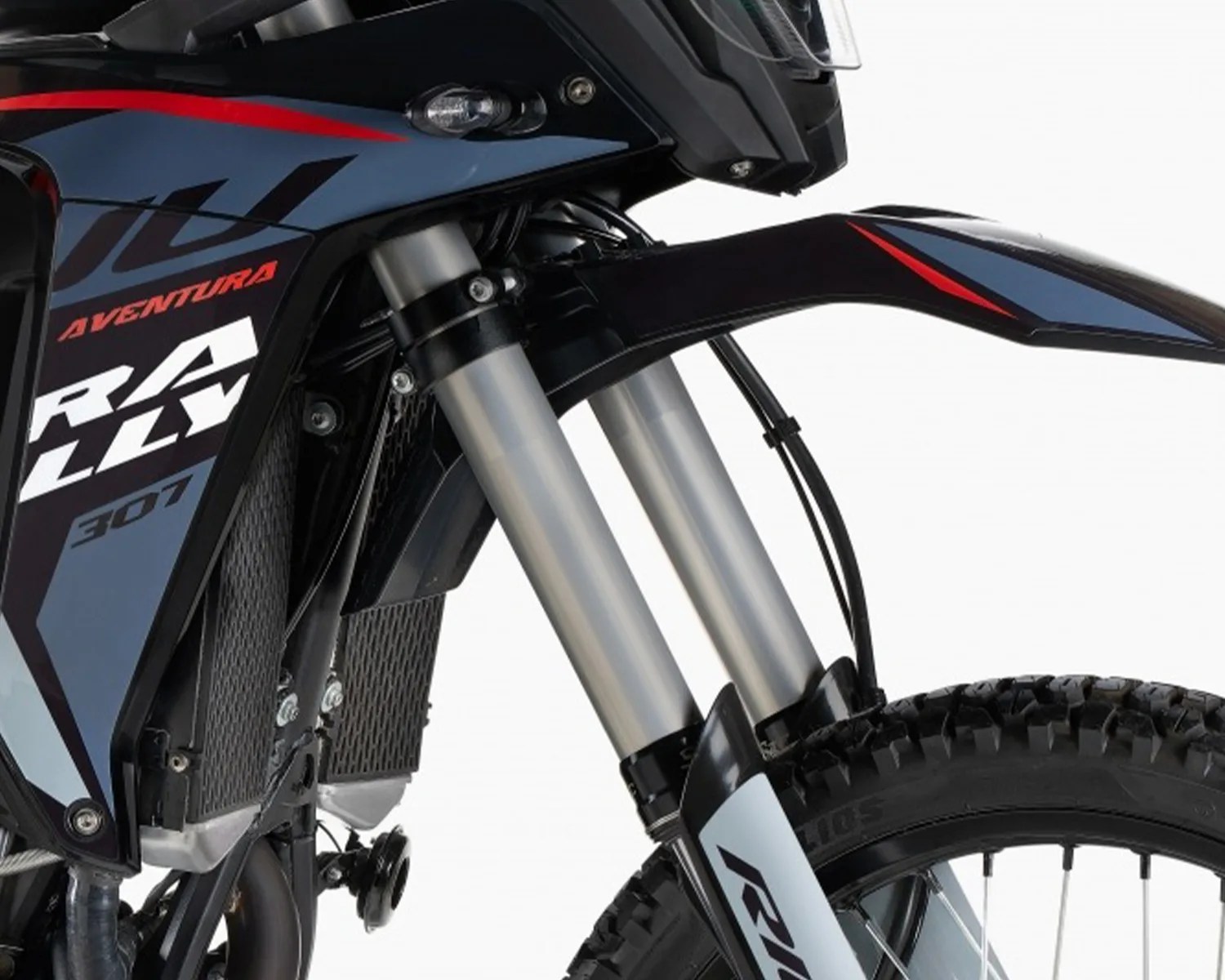Front suspension fork and front fender of a black and blue off-road motorcycle with "Rally 307" and "Aventura" decals.