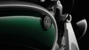 Close-up of a green Royal Enfield Flying Flea badge on a motorcycle fuel tank.