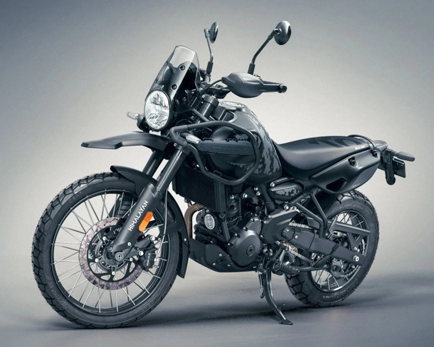 Matte black Royal Enfield Himalayan adventure motorcycle with spoked wheels and front windshield.