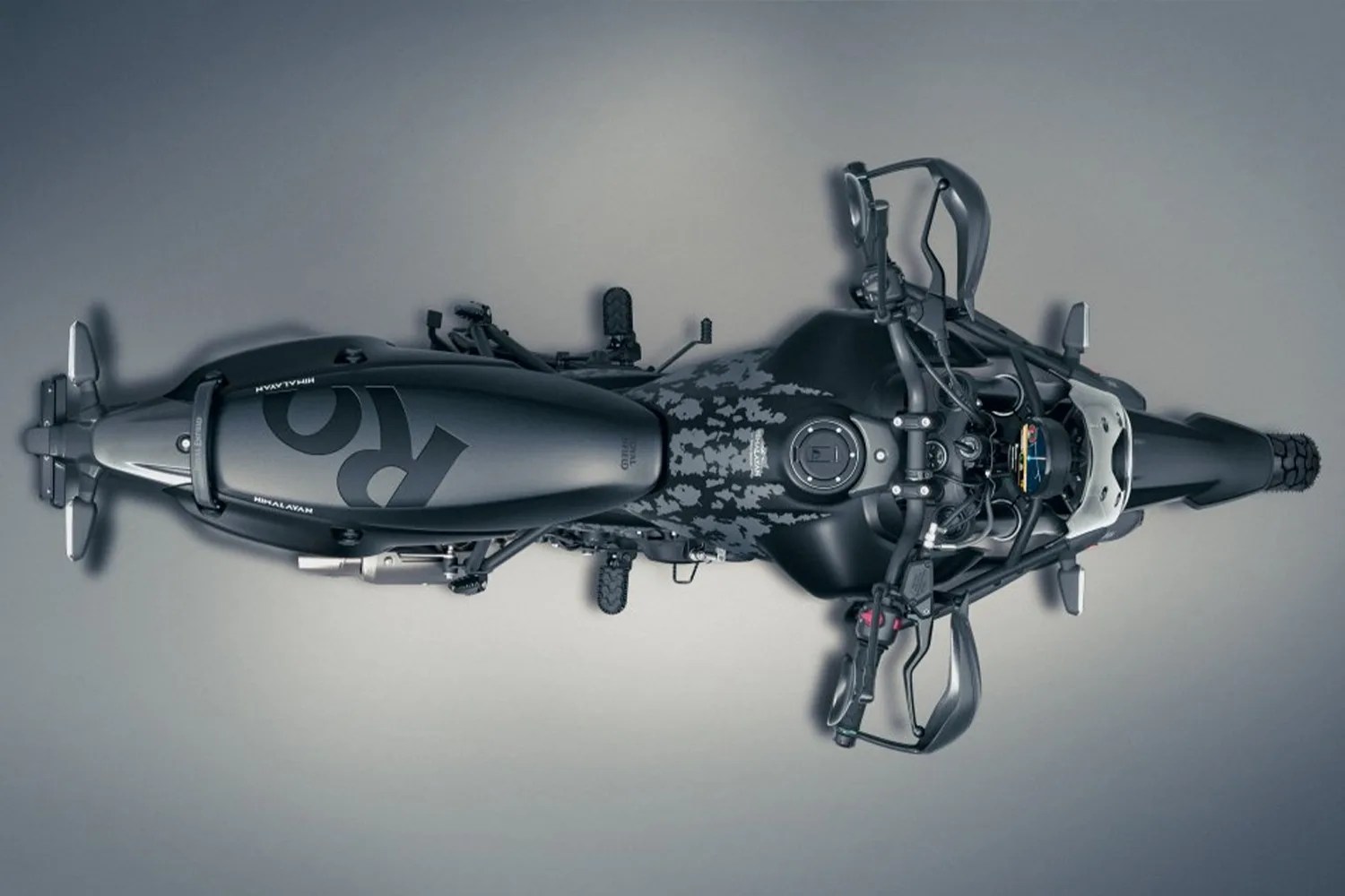 Top view of a black Royal Enfield Himalayan motorcycle with a patterned fuel tank and raised handlebars.