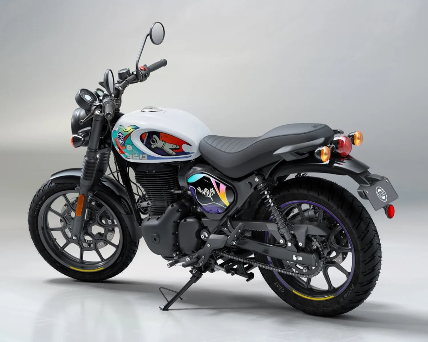 Black and white motorcycle with colorful graphic decals on the fuel tank and side panel, black seat, and alloy wheels.