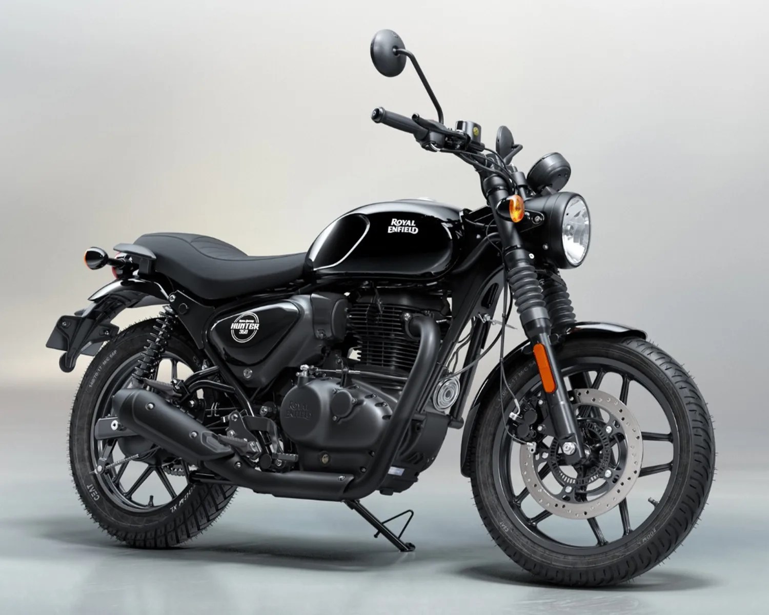 Black Royal Enfield Hunter 350 motorcycle with matte finish and alloy wheels on a gray background.