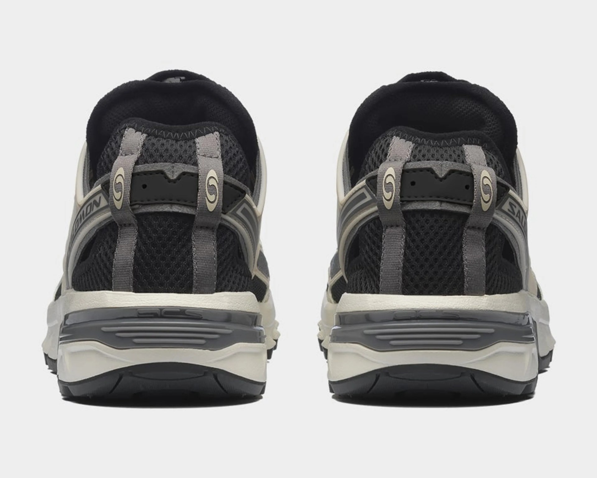 Pair of black and gray mesh athletic shoes shown from the back with white midsoles and gray pull tabs.