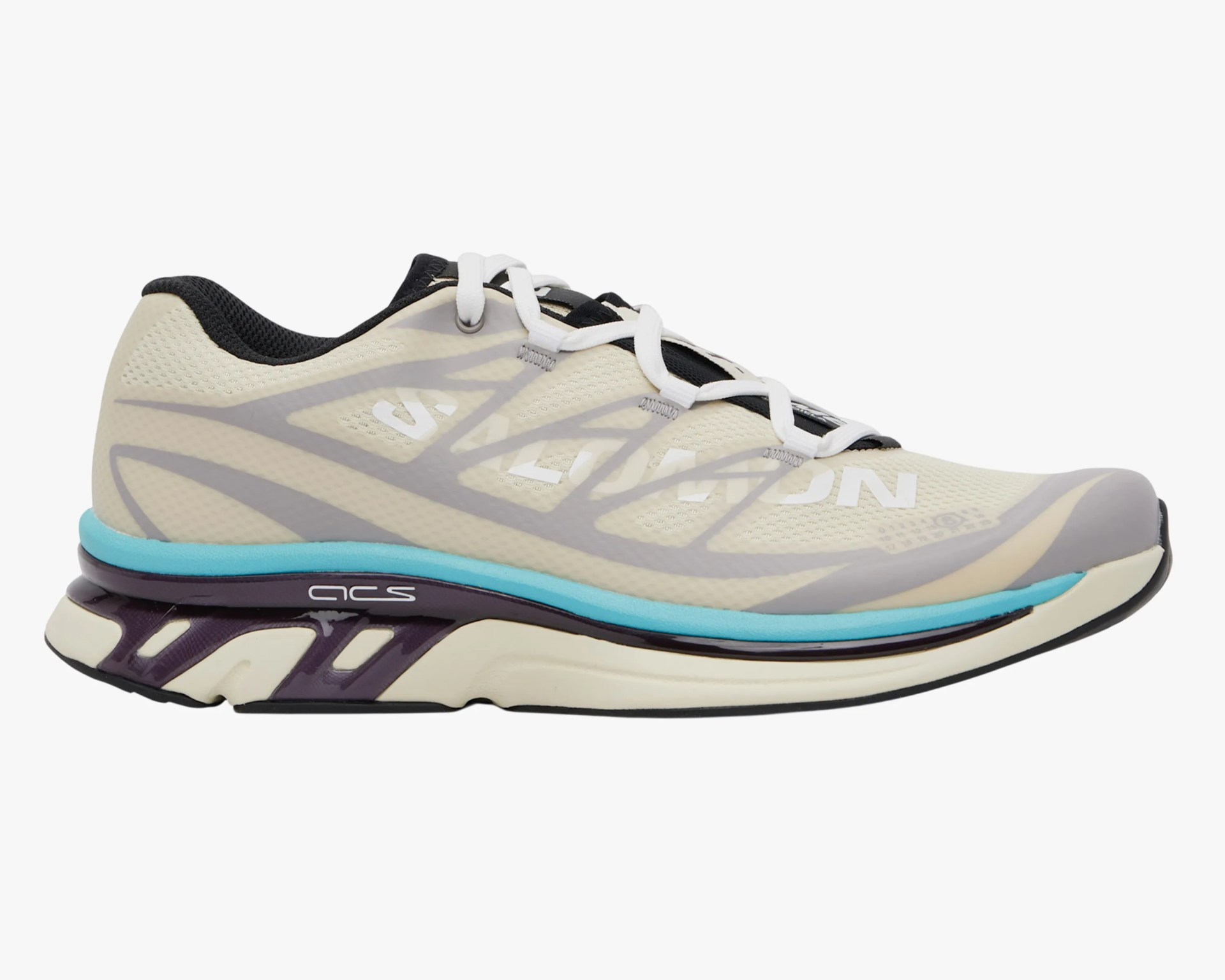 Beige and gray Salomon running shoe with white laces, black inner lining, and blue and black sole accents.