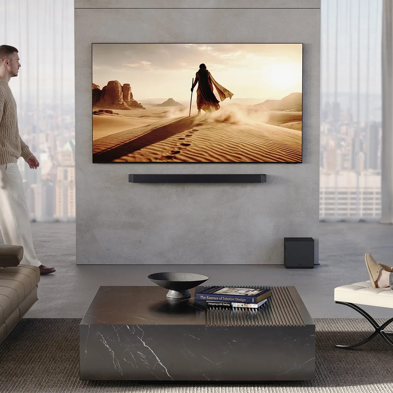 Wall-mounted flat-screen TV displaying a desert scene above a black soundbar and subwoofer in a modern living room.