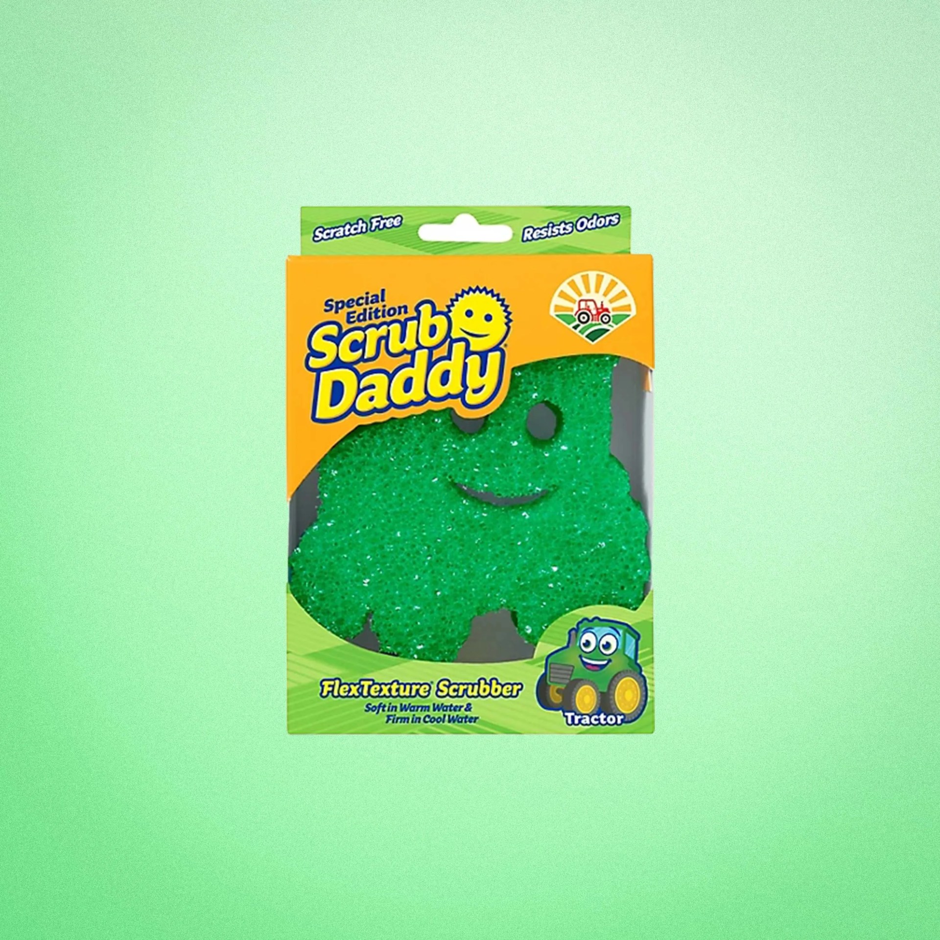 Green tractor-shaped Scrub Daddy FlexTexture scrubber in yellow and green packaging.