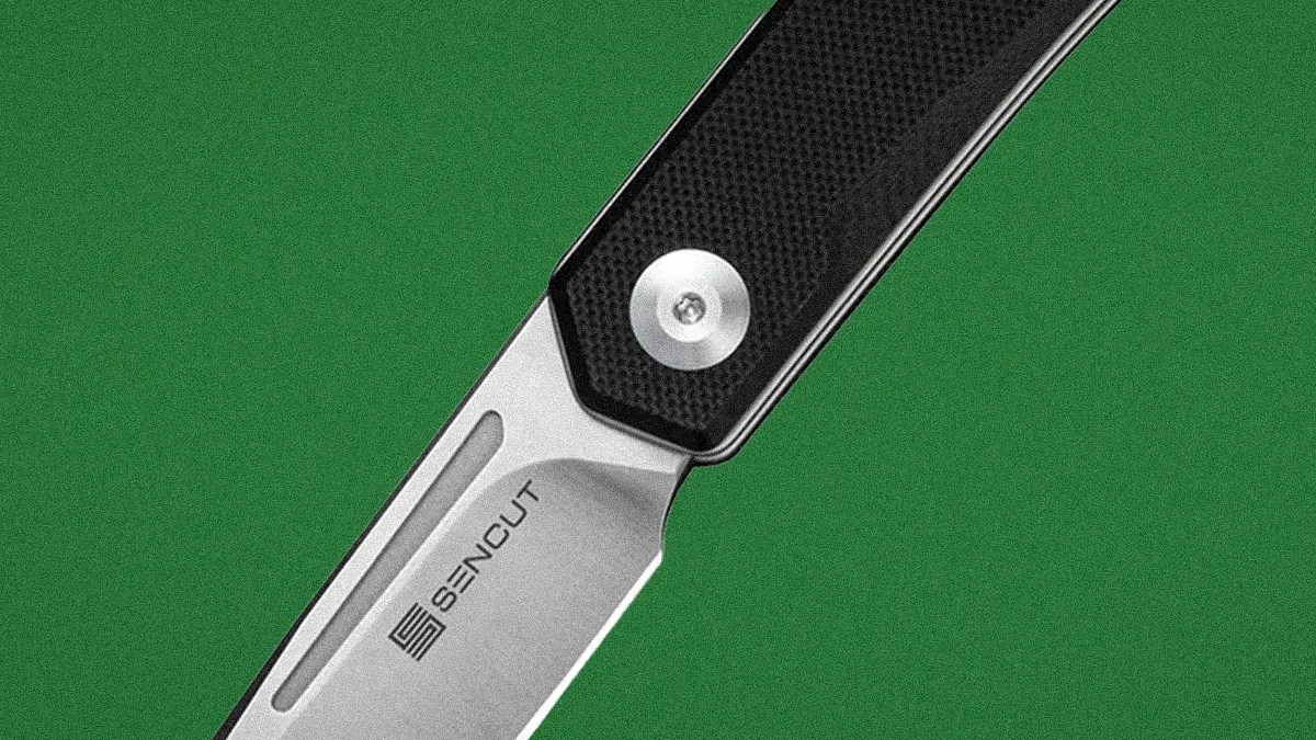 Close-up of a folding knife blade with "SENCUT" logo and a textured black handle.