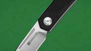 Close-up of a folding knife blade with "SENCUT" logo and a textured black handle.