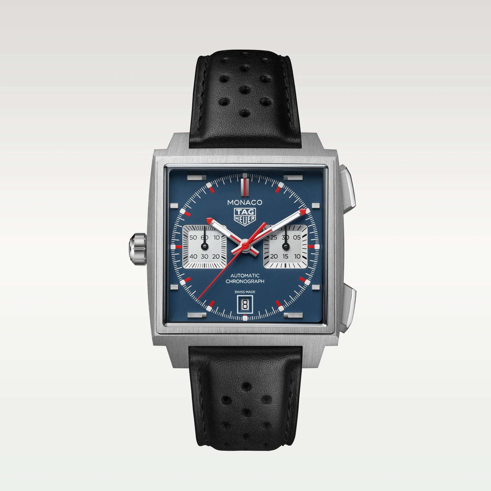Square stainless steel TAG Heuer Monaco watch with blue dial, red and white hands, two subdials, date window, and black perforated leather strap.