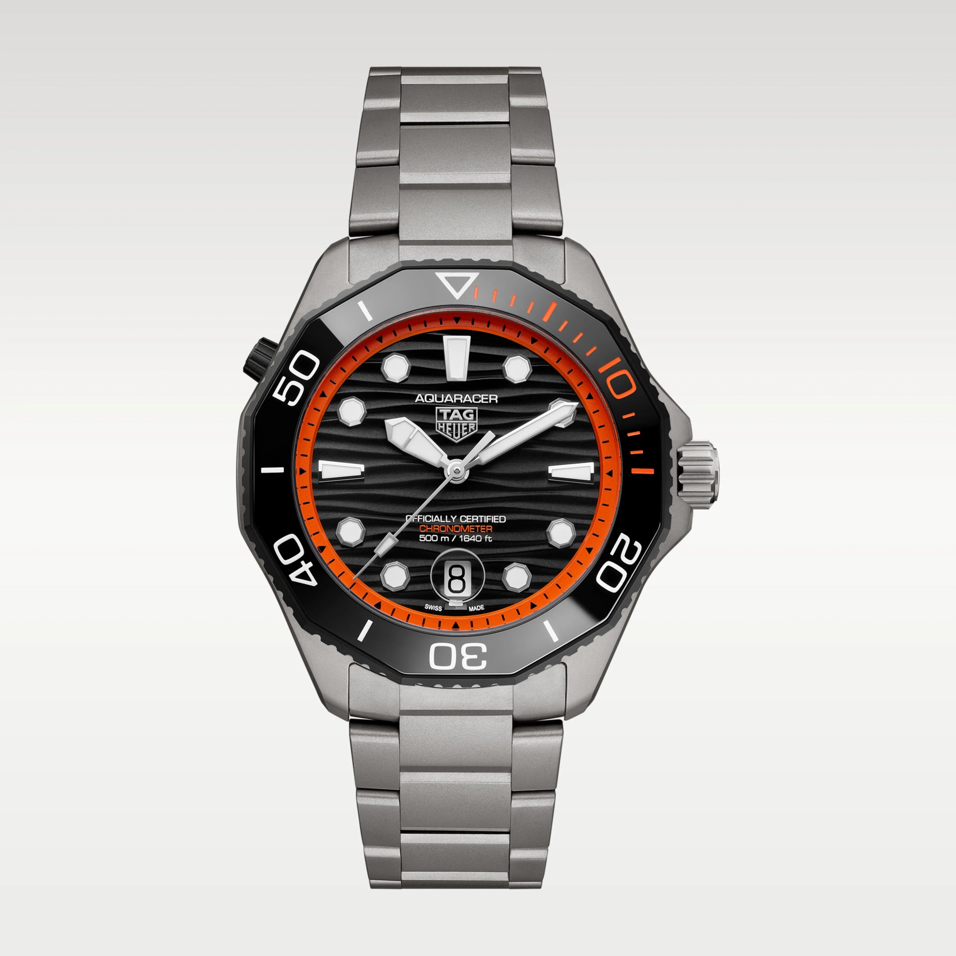 Stainless steel TAG Heuer Aquaracer watch with black dial, orange accents, and date display at 6 o'clock.