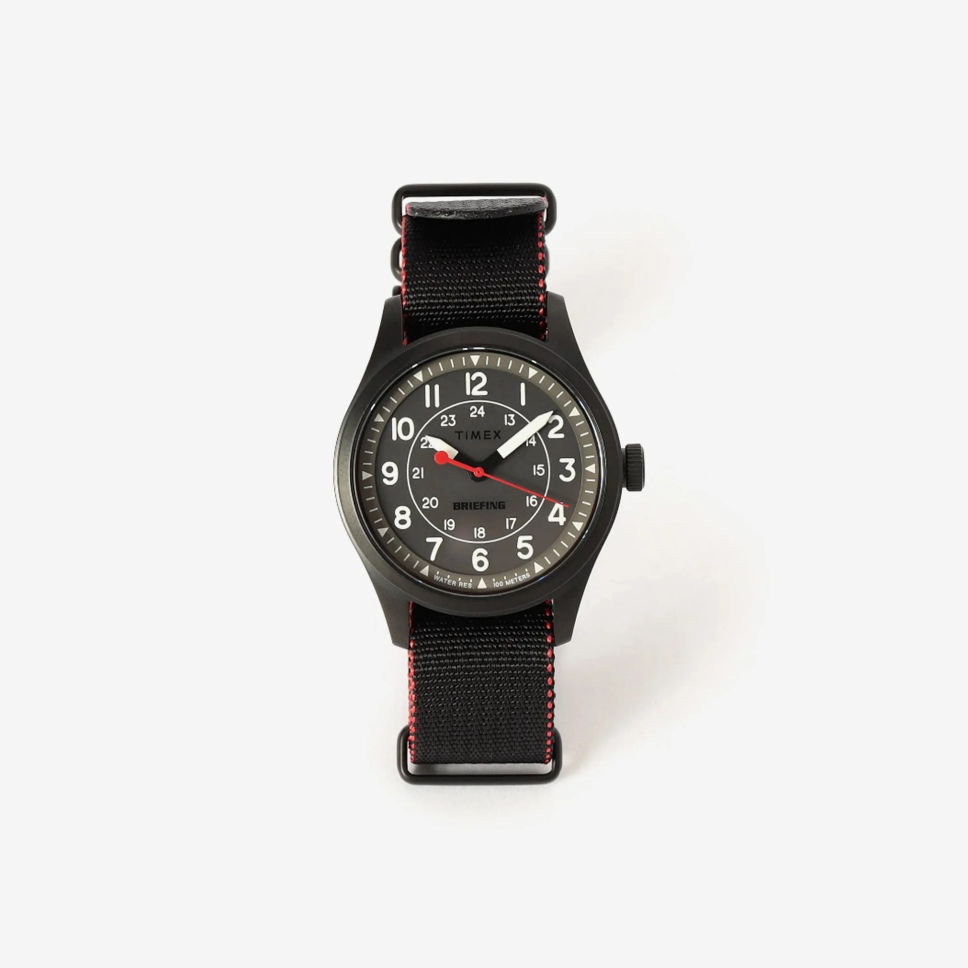 Black Timex wristwatch with red second hand and black fabric strap with red stitching on white background.