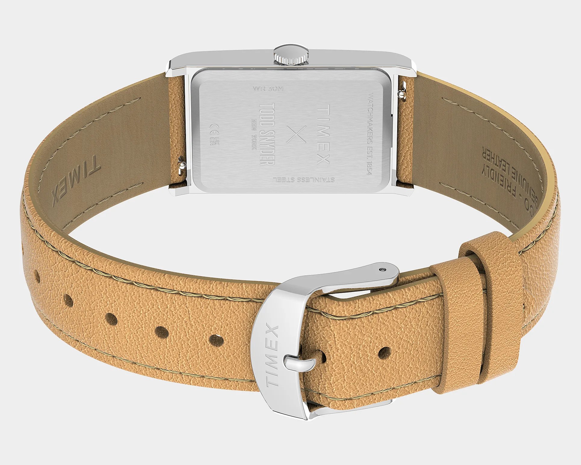 Silver rectangular watch case with engraved Timex x Todd Snyder logo and tan genuine leather strap with silver buckle.