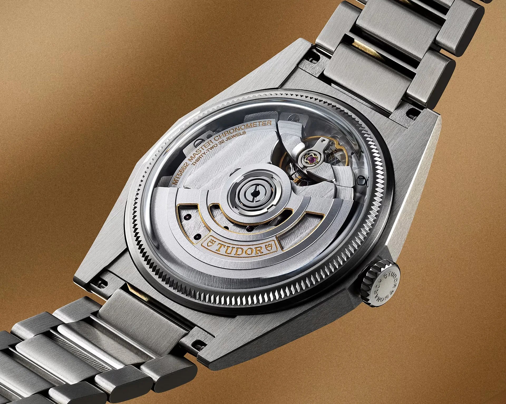 Close-up of the back of a Tudor watch showing the automatic movement with "TUDOR" and "MASTER CHRONOMETER" engraved on the rotor.