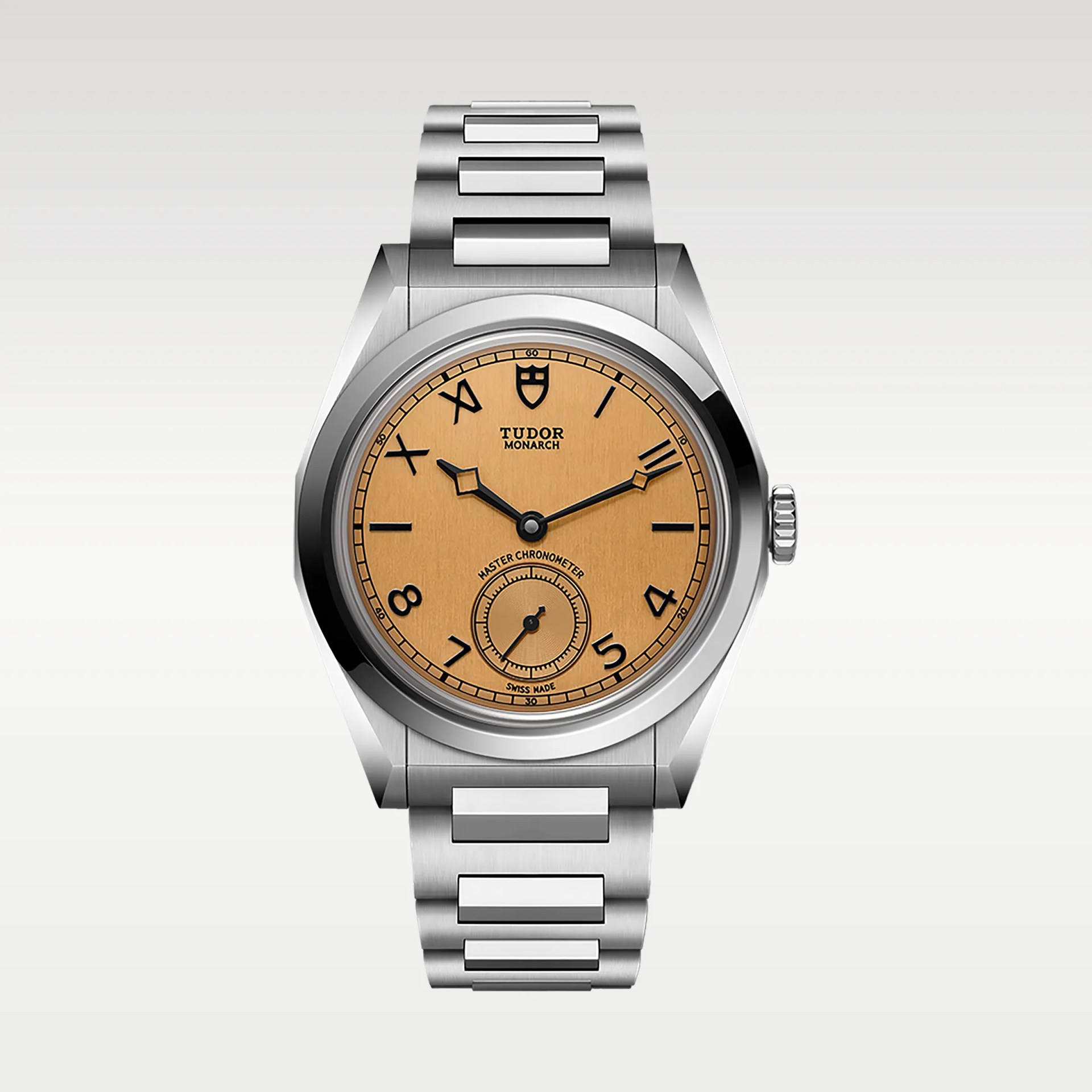 Stainless steel Tudor Monarch wristwatch with a brushed copper dial and black Roman and Arabic numerals.