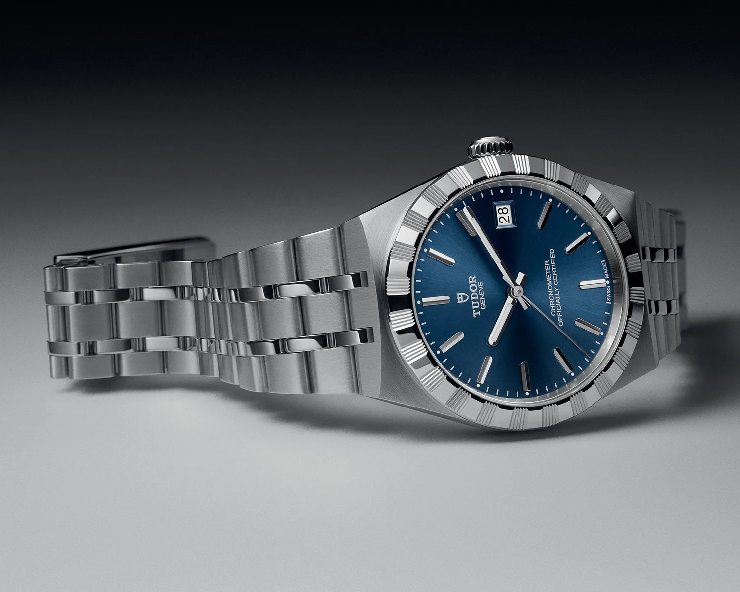 Stainless steel Tudor wristwatch with a blue dial, fluted bezel, and date window at 3 o'clock.