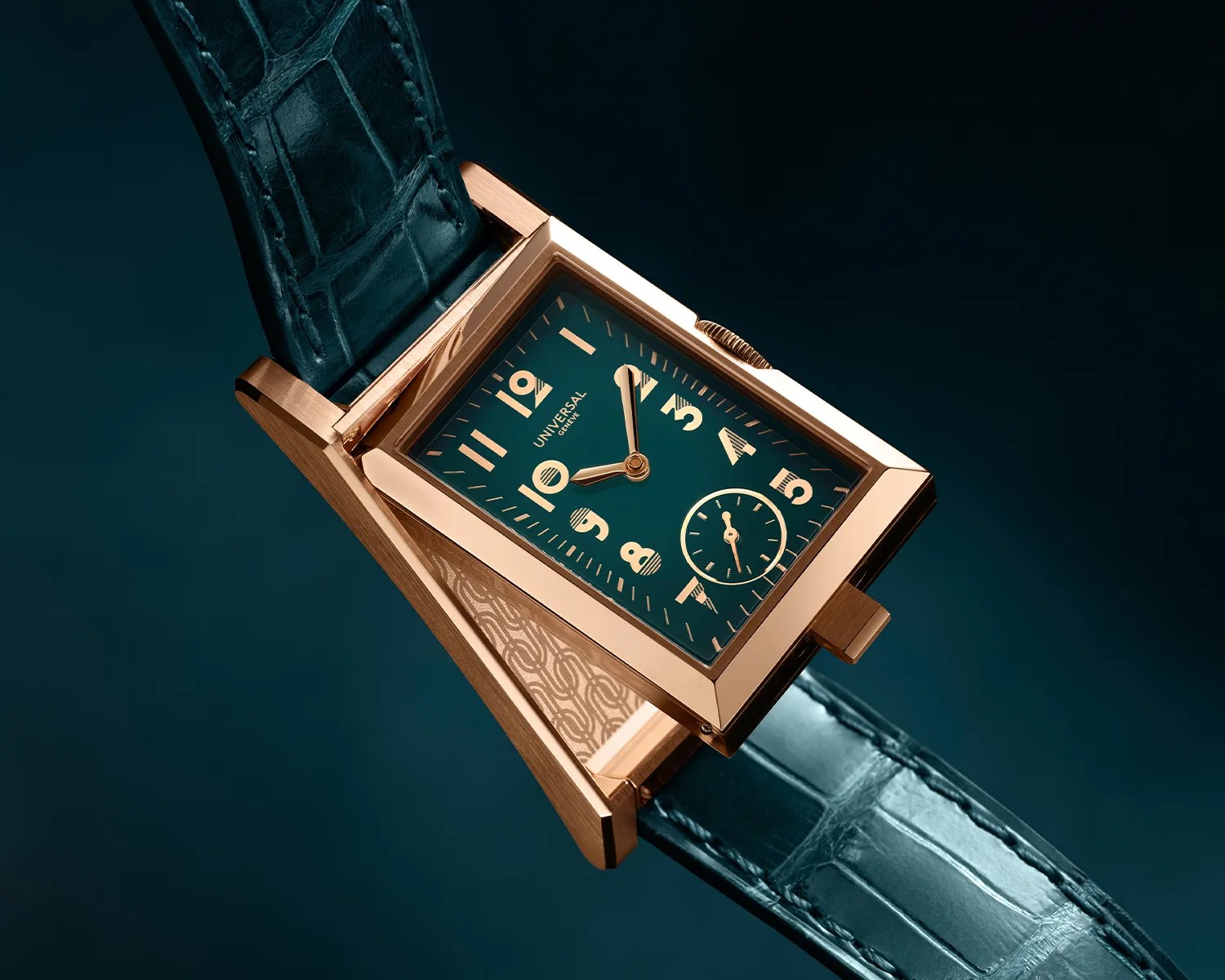 Rectangular rose gold wristwatch with teal dial, gold numerals, small seconds subdial, and teal alligator leather strap.