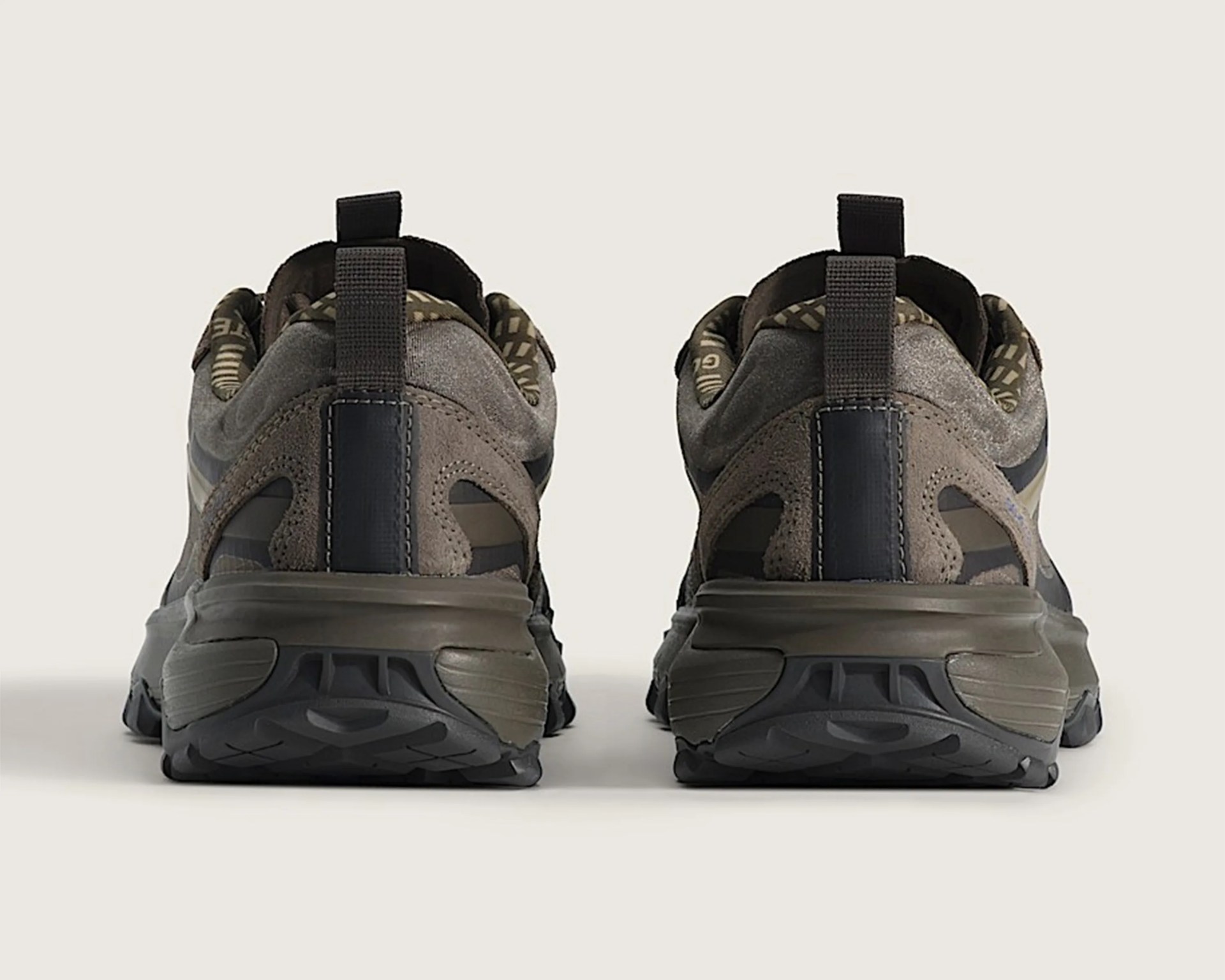 Pair of brown and black athletic shoes shown from the back on a neutral background.