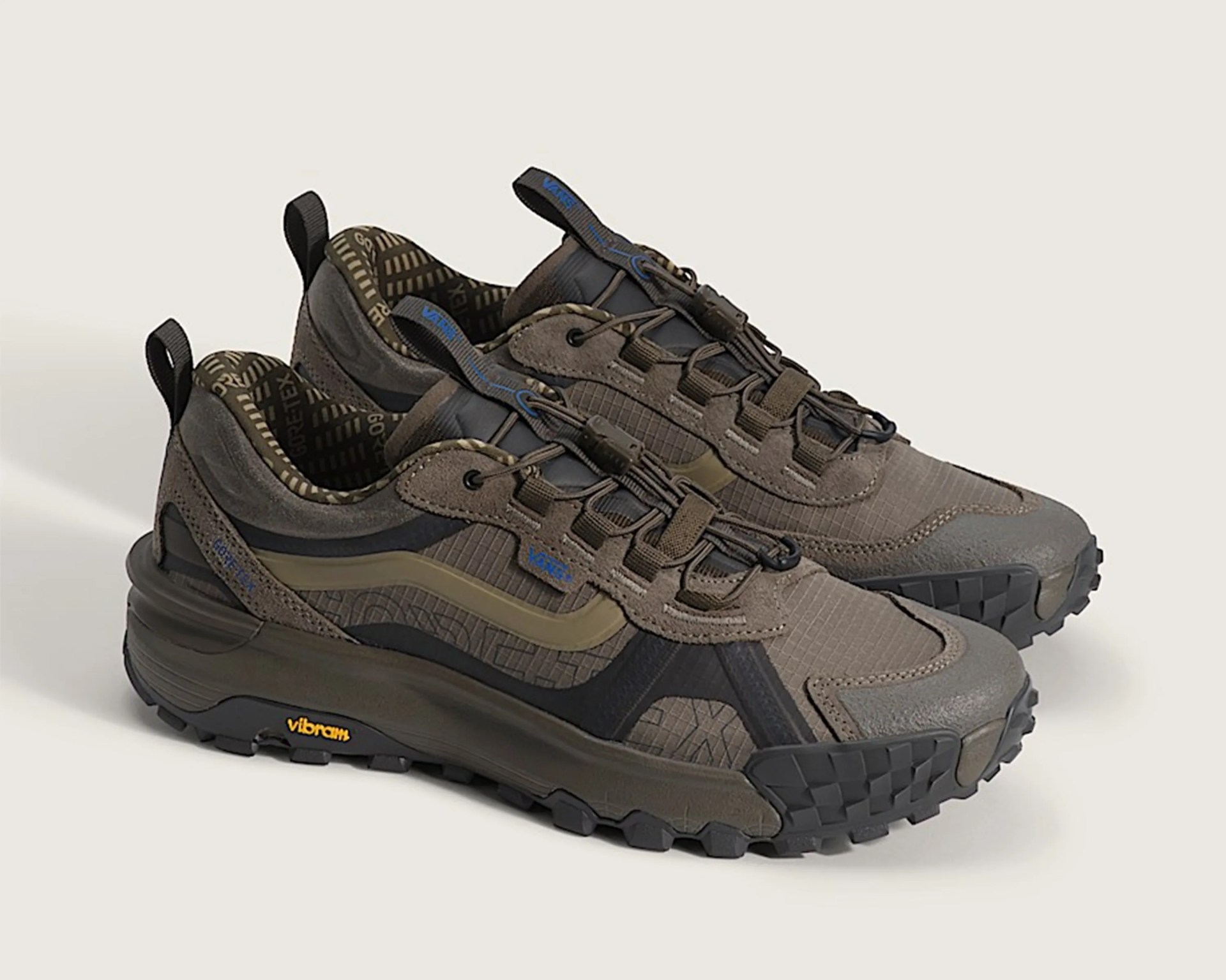 Pair of brown and black Vans hiking shoes with Vibram soles and Gore-Tex lining on a light background.