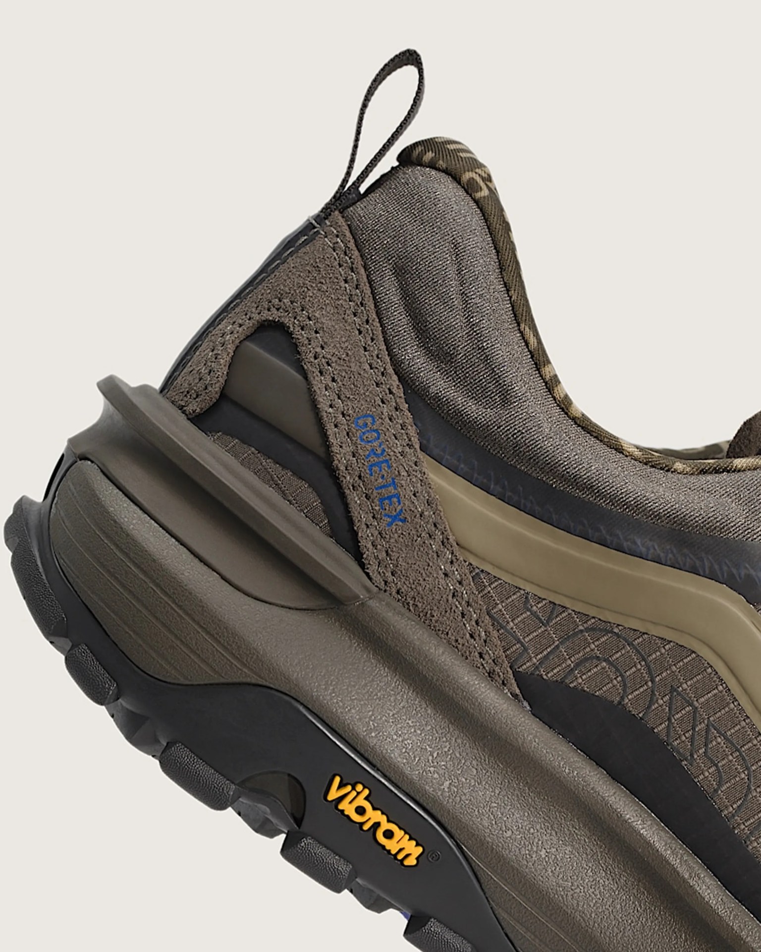 Close-up of a brown and black Gore-Tex sneaker with Vibram sole and pull tab at the heel.