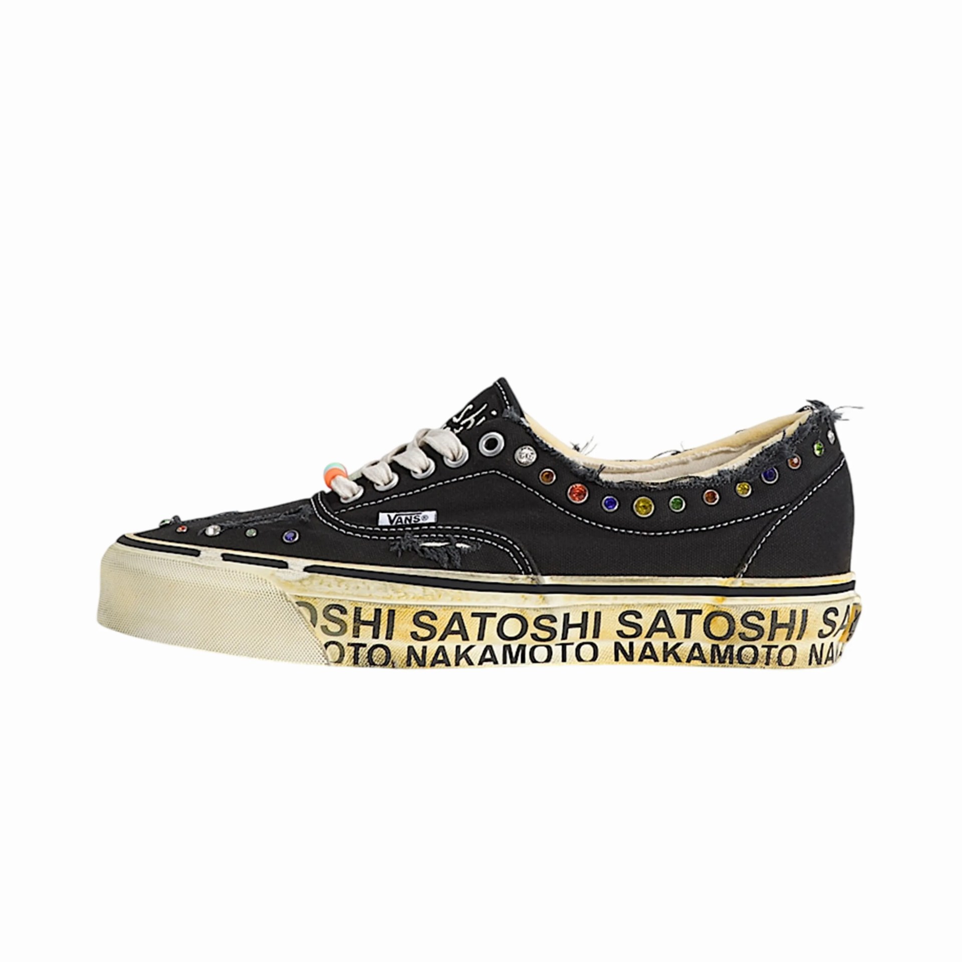 Black Vans sneaker with frayed edges, multicolored studs, white laces, and a yellow sole printed with "Satoshi Nakamoto.
