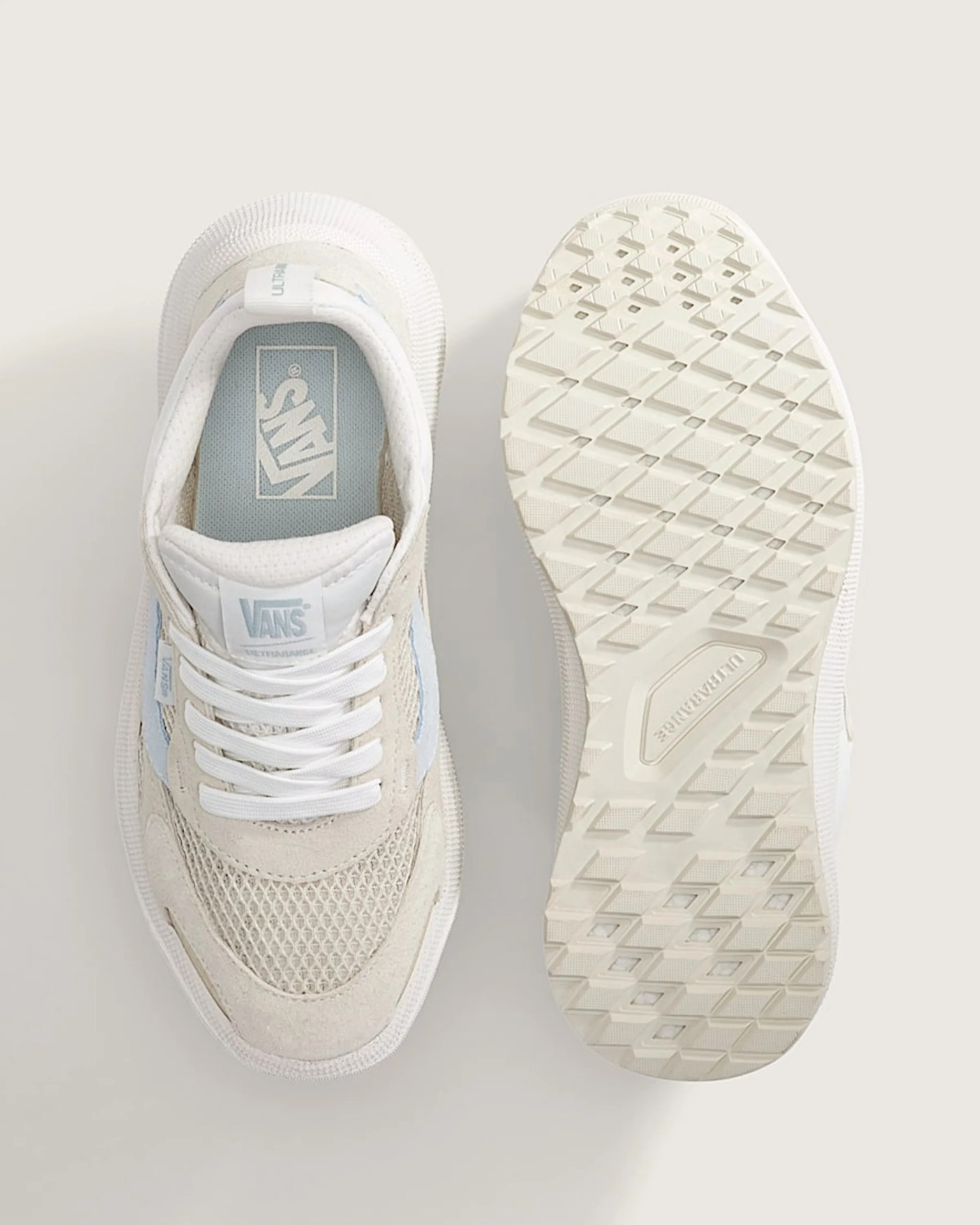 Pair of off-white Vans sneakers with mesh and suede upper, white laces, and textured rubber sole shown from top and bottom.