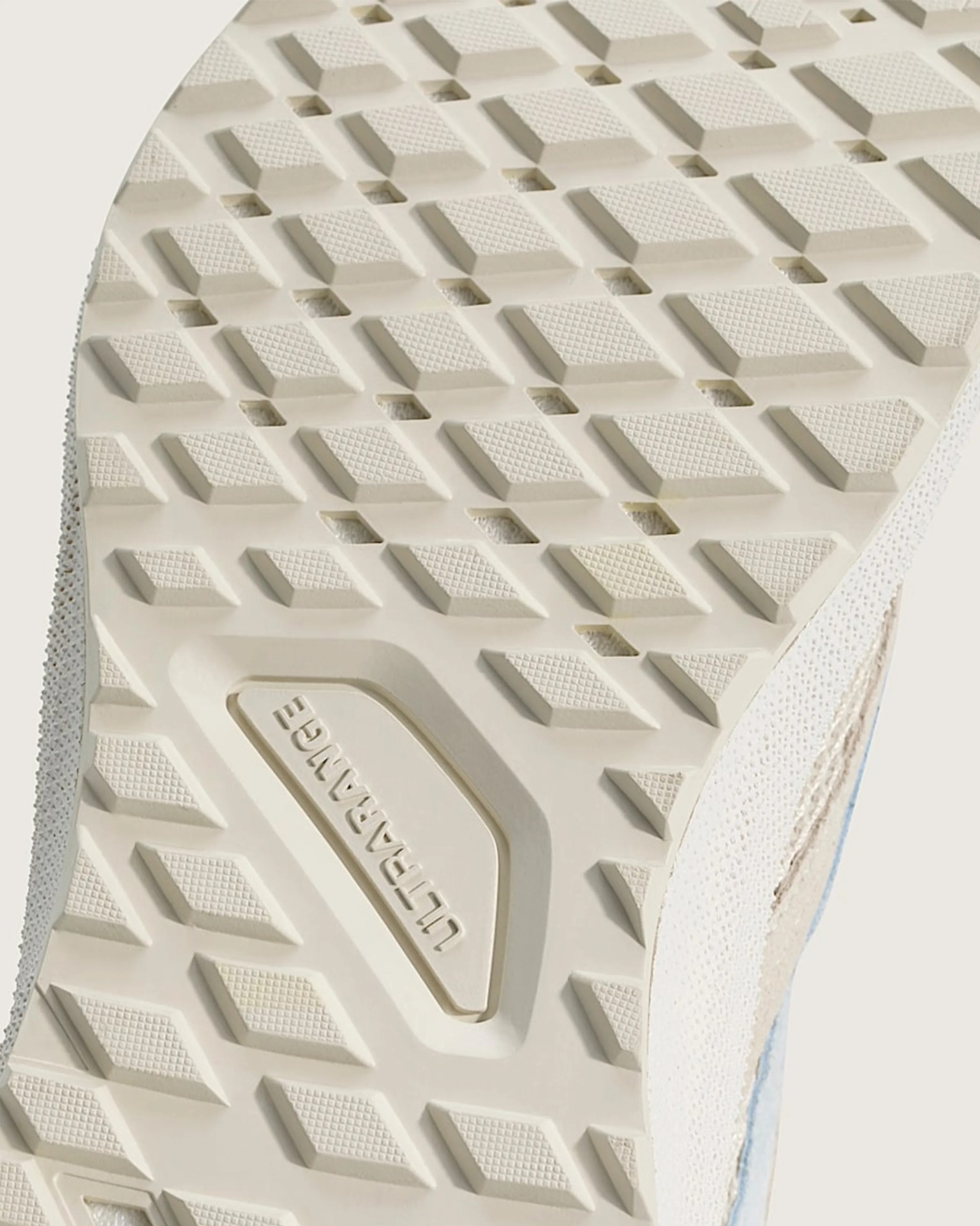 Close-up of a beige shoe sole with a diamond tread pattern and "ULTRARANGE" embossed in the center.