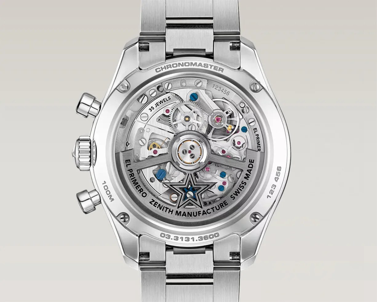 Back view of a Zenith Chronomaster watch showing the intricate El Primero movement with visible gears and jewels inside a stainless steel case and bracelet.