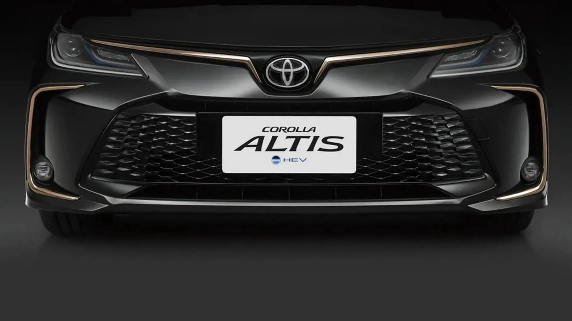 Front view of a black Toyota Corolla Altis HEV with gold trim accents around the grille and headlights.