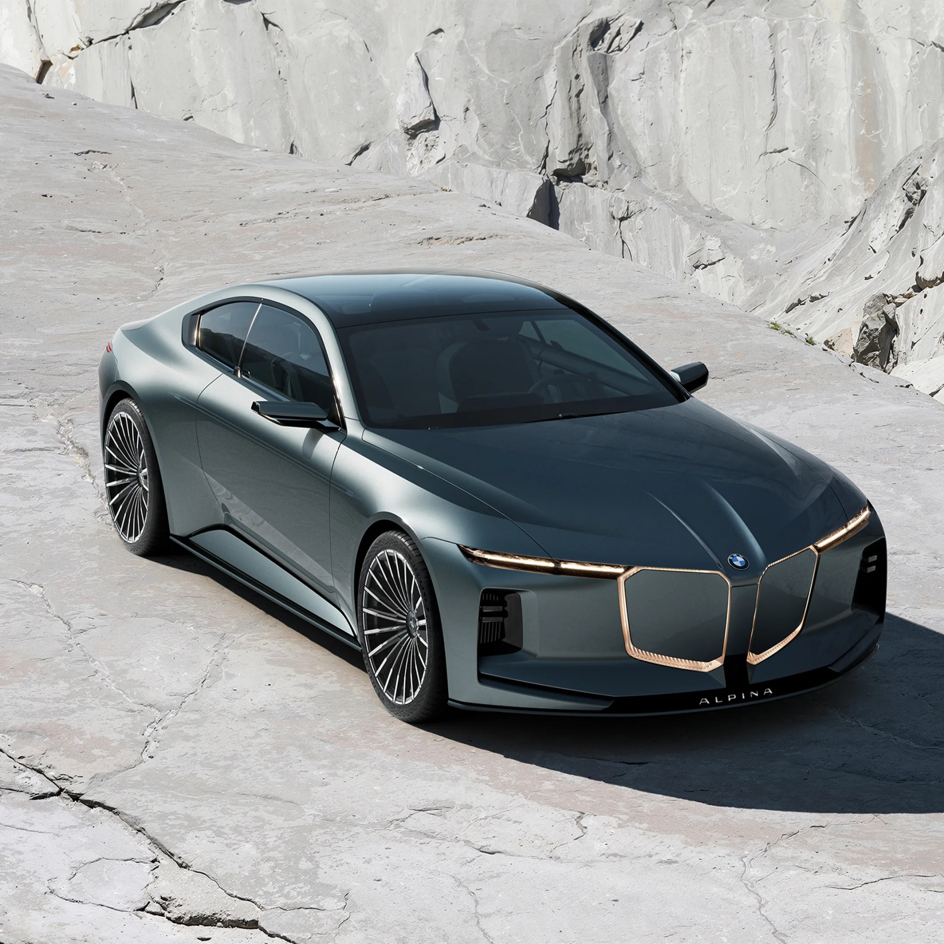 Metallic gray BMW Alpina luxury sedan with gold-accented kidney grille parked on cracked stone surface.