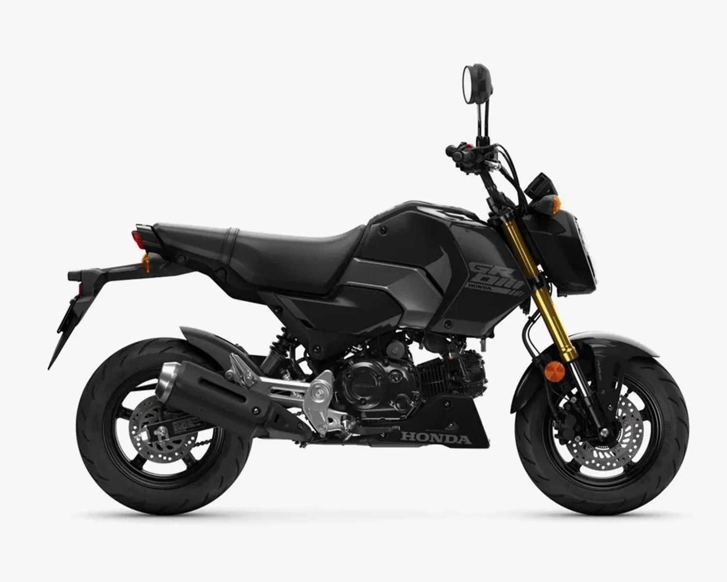 Black Honda Grom motorcycle with gold front forks and disc brakes on white background.