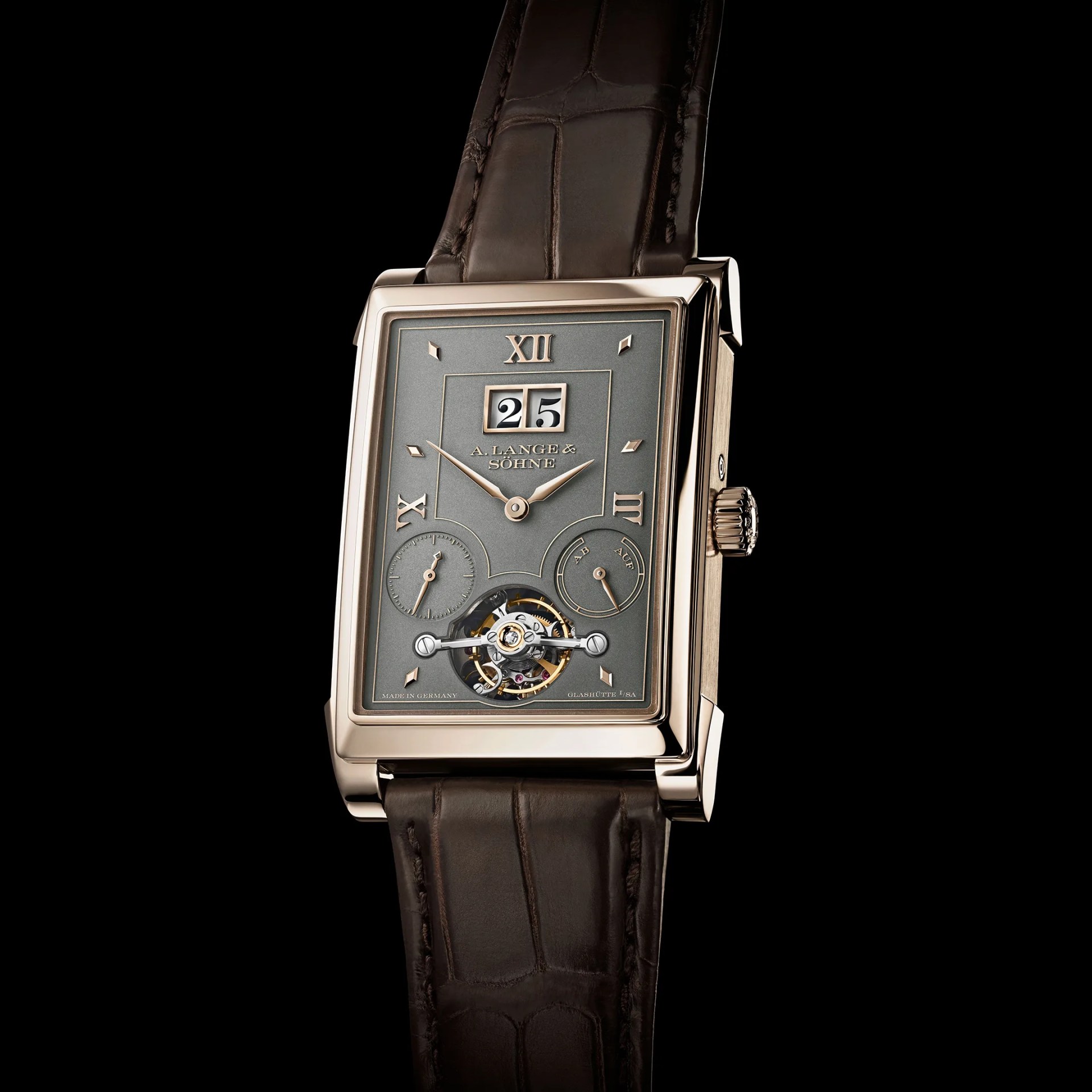 Rectangular luxury wristwatch with a rose gold case, gray dial, Roman numerals, tourbillon, and dark brown leather strap.