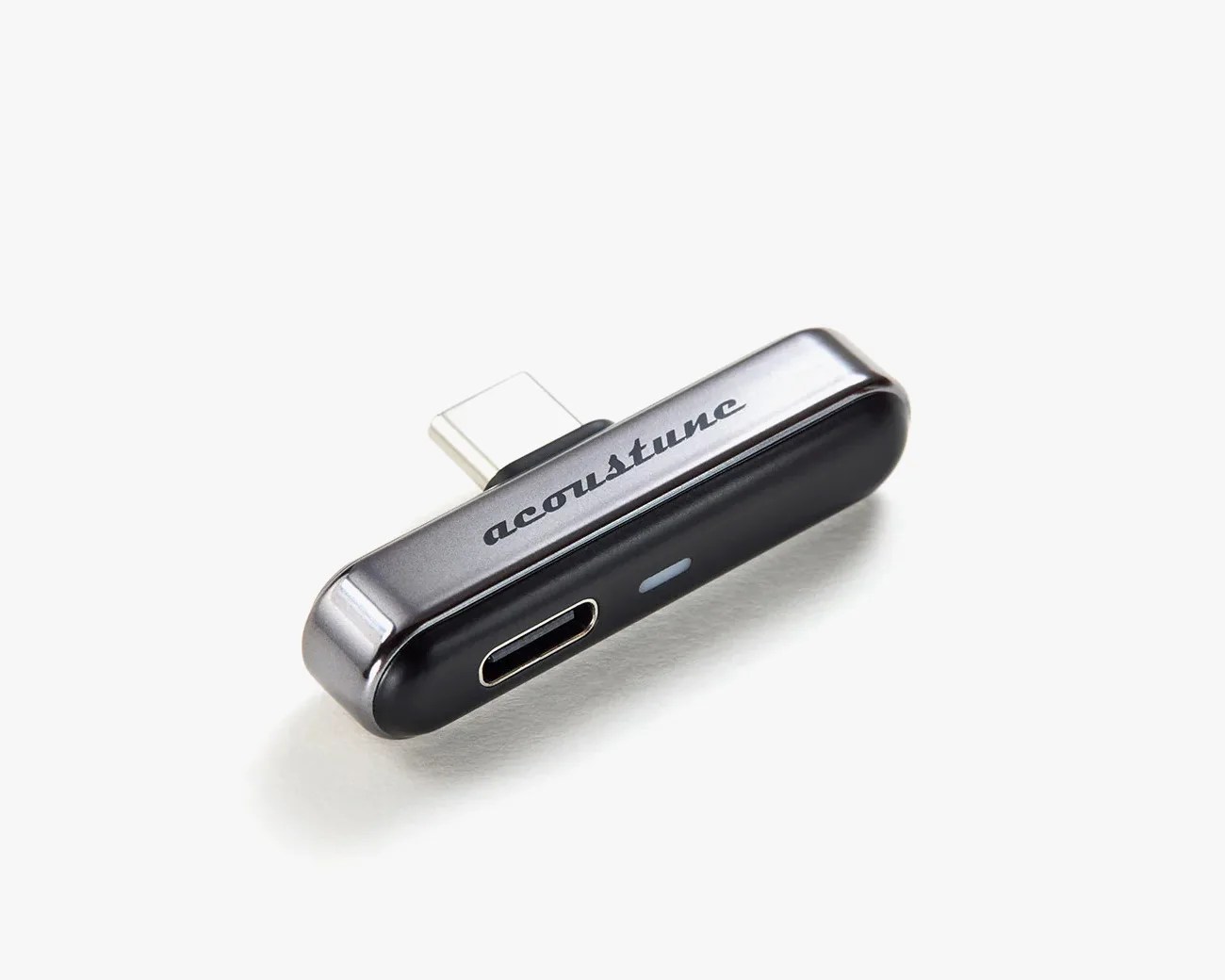 Black and gray Acoustune USB-C adapter with a USB-C port on a white background.
