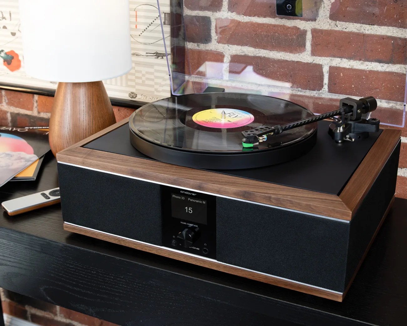 Wood-framed Andover Phono 33 turntable with black fabric speakers and digital display on a black shelf.