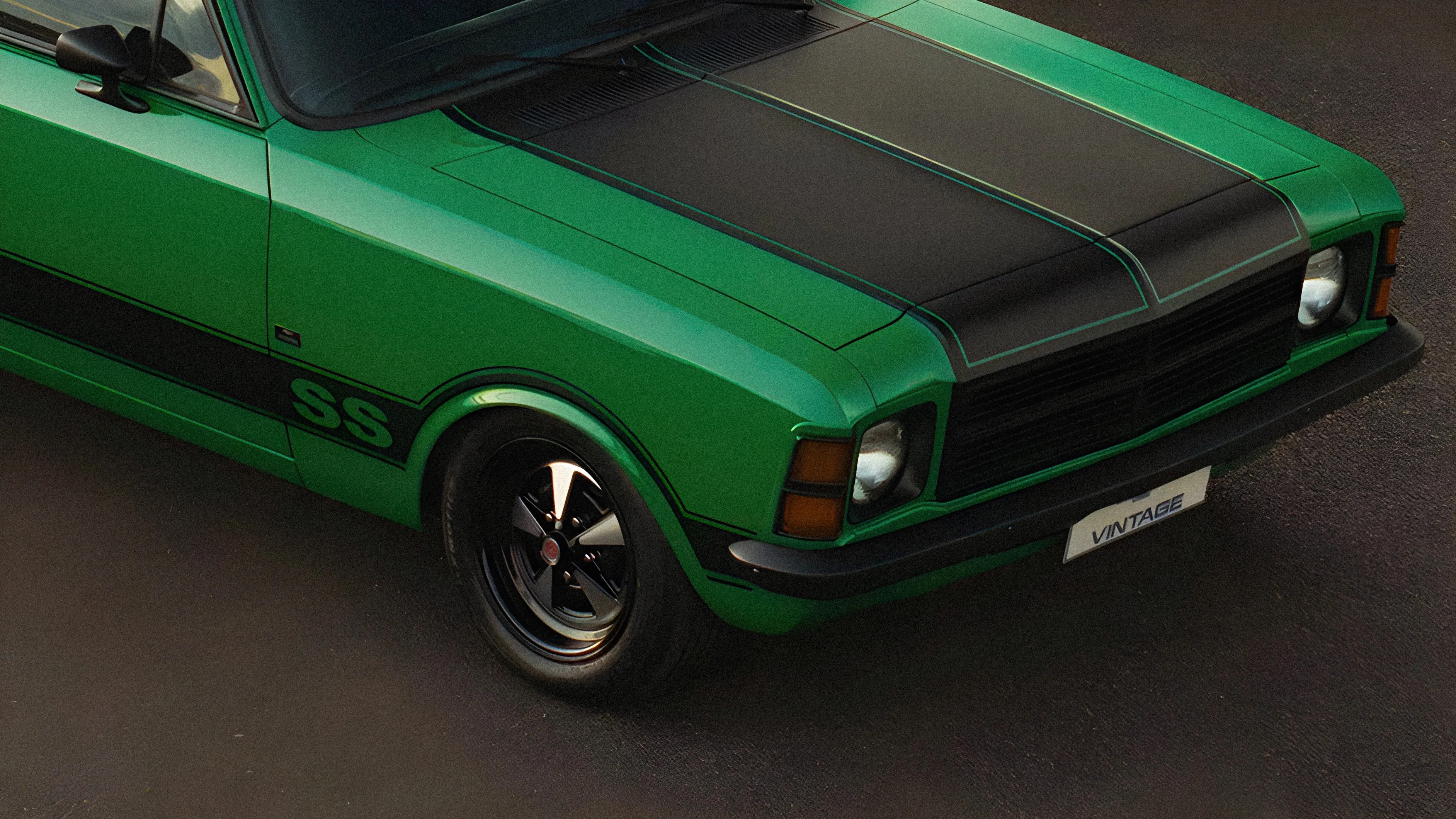 Green vintage muscle car with black hood stripes and black wheels on asphalt.