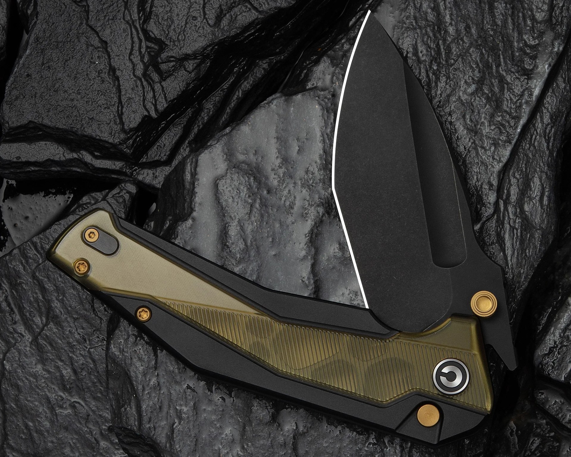 Folding knife with black blade and olive green textured handle on dark textured surface.