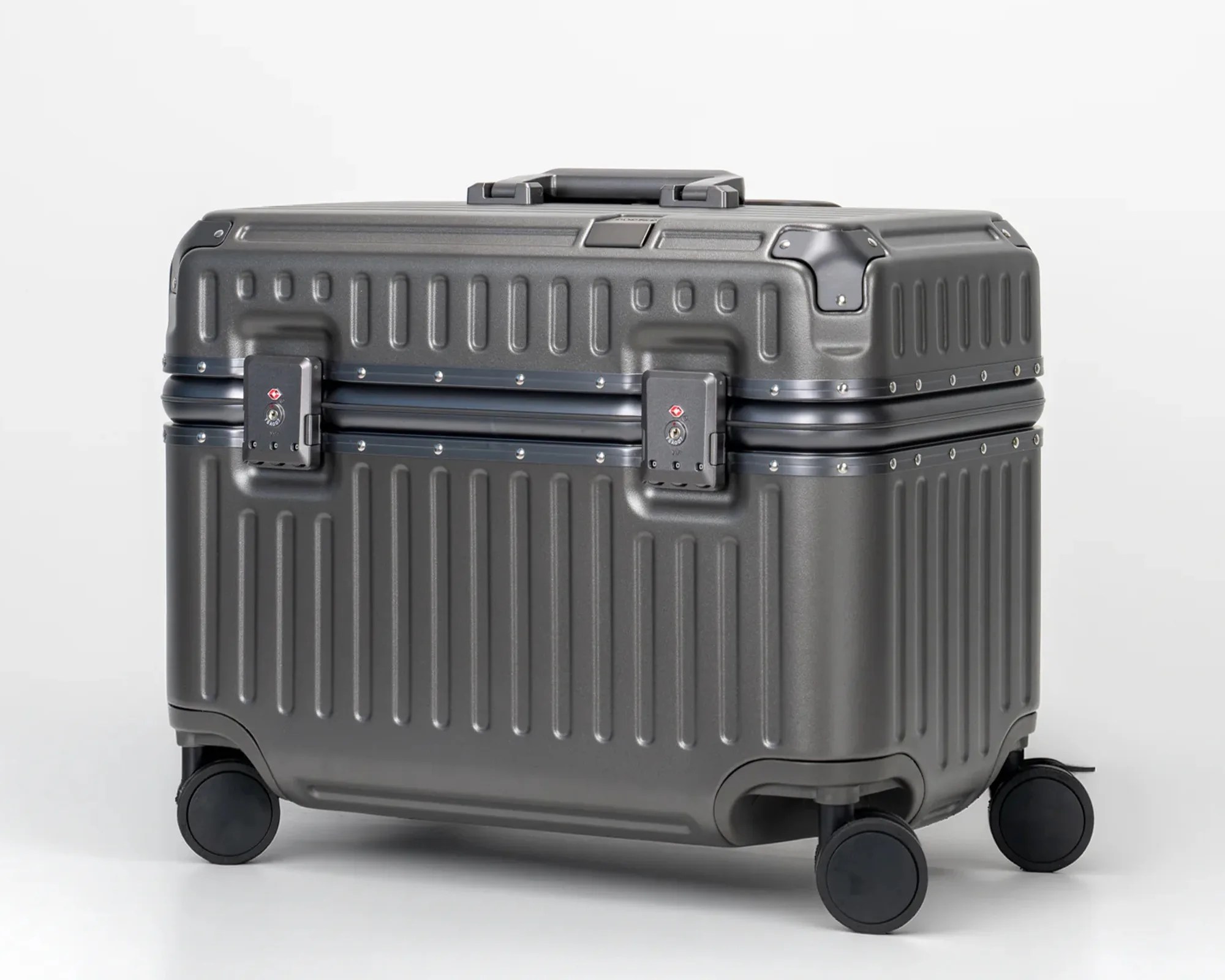 Dark gray hard-shell suitcase with four spinner wheels and two TSA locks on a white background.