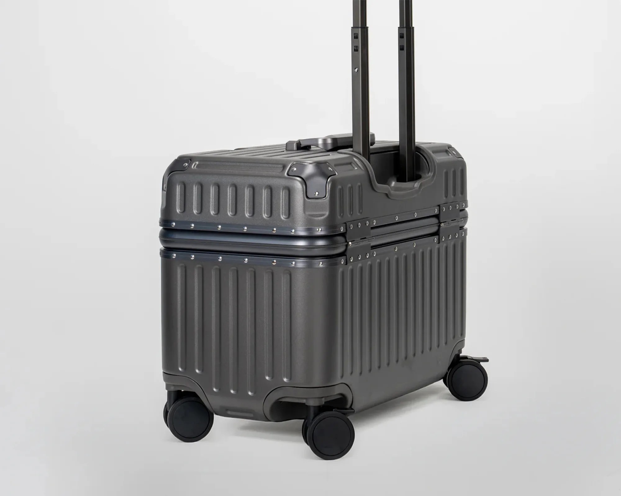 Black hard-shell suitcase with four wheels and an extended telescopic handle.