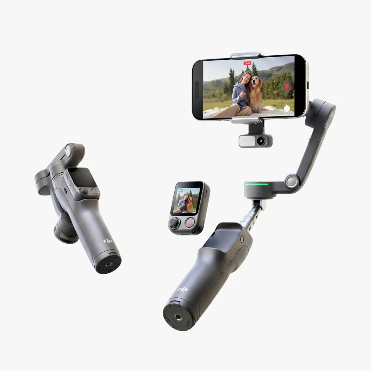 Two black DJI handheld gimbals, one holding a smartphone showing a woman and dog on screen, and a small remote control with display.